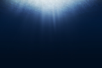 Wall Mural - dark blue ocean surface seen from underwater. abstract waves underwater and rays of sunlight shining