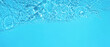 Transparent blue clear water surface texture with ripples, splashes and bubbles. Abstract summer banner background Water waves in sunlight with copy space Cosmetic moisturizer micellar toner emulsion