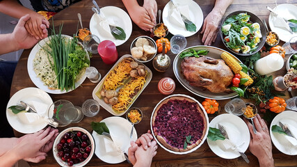 thanksgiving dinner with the family. children , grandchildren of grandparents hold each other's hands. prayer.