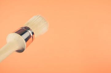 Poster - Closeup shot of a brush on an orange background