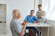 © SHOTPRIME STUDIO - male doctor with a nurse examining an elderly woman