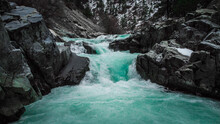 Blue-green Waterfall And River Cutting Through Rocks.