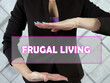  FRUGAL LIVING inscription on the screen.  Frugal living is the act of being very intentional with your spending.
