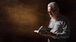 © Mongkolchon - senior old christian man holding and reading holy bible book