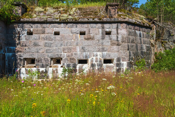 Wall Mural - Fortified wall in a moat with a flowering meadow