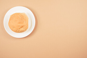 Sticker - Top view of bread bun on a plate isolated on a brown background