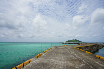 a wonderful seascape with emerald green water and charming clouds