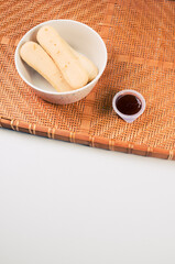 Sticker - Cookies with ketchup dip on a bamboo wicker tray isolated on gray background