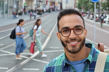 Wall Mural - Young ethnic adult walking on the street 