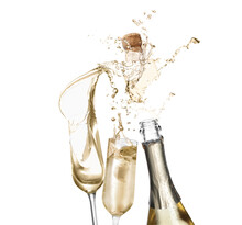 Sparkling Wine Splashing Out Of Bottle And Glasses On White Background