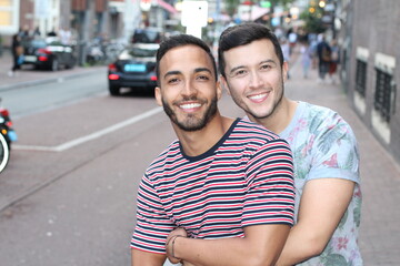 Wall Mural - Two cute guys showing affection outdoors 