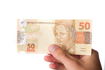 Wall Mural - Brazillian Money, man holding 50 Reais notes isolated on white