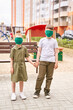 © elenavolf - Children in safety mask. New normal. Corona virus safety portrait. Boy and girl. Family. Playground background. Outdoors. Health care