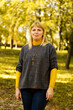 © tanitost - Defocus light smiling blond 40s woman standing in yellow autumn park. Happy beautiful lady. Women wearing grey pullover, yellow turtleneck, pendant, jeans. Fall park, leaves. Vertical. Out of focus