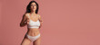 © master1305 - Young adorable woman in white lingerie isolated over pink studio background. Natural beauty concept.
