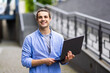 © F8  \ Suport Ukraine - Young handsome freelancer sitting at street free time with new laptop