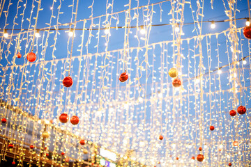 Lights of Christmas garlands on the background of the evening sky