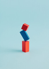 Geometric 3D shapes in vertical composition on blue background. Creative gravity concept.
