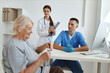 © SHOTPRIME STUDIO - a nurse and a doctor communicating with an elderly woman patient in a medical office