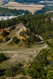 Fototapeta  - Koneprusy, Czech Republic, 24 July 2021: Deep opencast Limestone mine leaves great environmental impact, calcite quarry in Bohemian karst, landscape near Koneprusy caves in Beroun region
