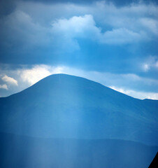 Wall Mural - sun rays and rain in the carpathian mountains in summer
