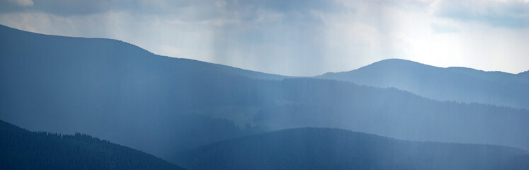 Wall Mural - sun rays and rain in the carpathian mountains in summer