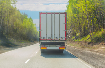 Sticker - Truck Moves Along Country Road along the forest.