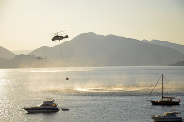  Russian  helicopter draws water from the sea to extinguish a forest fire. Marmaris,Turkey