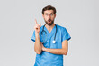 Covid-19, quarantine, hospitals and healthcare workers concept. Excited thoughtful bearded doctor in scrubs, stethoscope, raising index finger in eureka gesture, have idea or plan, grey background