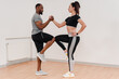 © Denys Kurbatov - Happy multinational couple stretching together during fitness training