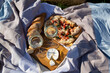 picnic in nature: pizza, cheese, baguette and glasses of wine