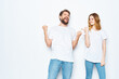 © SHOTPRIME STUDIO - cheerful young couple in white t-shirts and jeans studio posing light background