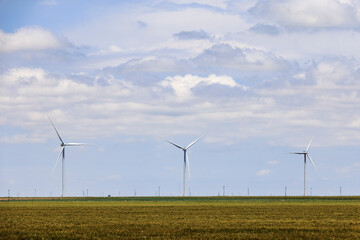 Wind turbines generate electricity near farms in West Texas.