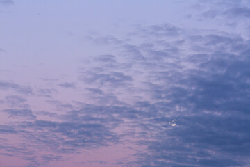 Wall Mural - Image of full moon against colorful evening sky with light clouds