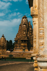 Poster - Vertical shot of a temple of Khajuraho on blue sky background in India