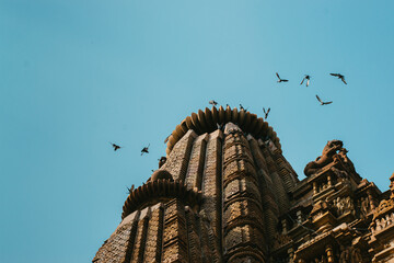 Poster - Scenic view of a temple of Khajuraho on blue sky background in India