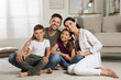 © New Africa - Portrait of happy family in living room. Adoption concept