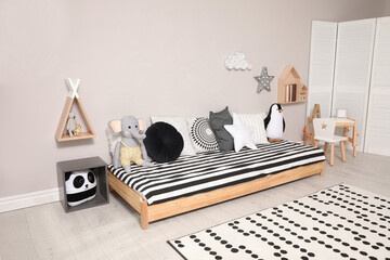 Poster - Cute kids room with stylish comfortable floor bed and toys. Montessori interior