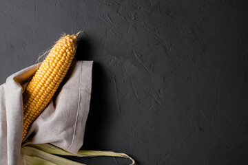 Wall Mural - Peeled raw corn on a gray concrete background.