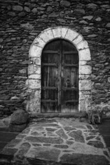 Old door of a small town in the Pyrenees of Andorra. Mountain architecture. Rock, stone and wood
