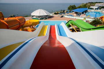 Wall Mural - Colorful slides in water park on sunny day