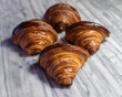 © Cavan - four croissants on white marble