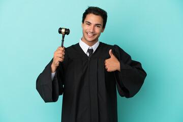 Wall Mural - Judge over isolated blue background giving a thumbs up gesture