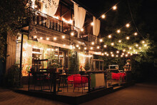 Beautiful View Of Modern Cafe With Outdoor Terrace At Night