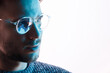 © KDdesignphoto - Man in glasses with futuristic holographic interface to display data. Portrait of beautiful young male. Augmented reality, future technology, internet concept.
