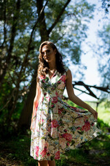 Poster - Young beautiful Caucasian female from Bosnia and Herzegovina wearing an elegant floral dress