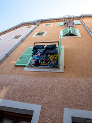 Sticker - laundry hanging at the window of town house in small village in the French Riviera back country