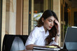© Prathankarnpap - Stressed businesswoman holding her head and working with laptop in office.