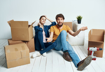 Wall Mural - young couple moving boxes with things home routine