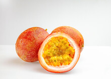 Juicy Passion Fruit Pulp. Passion Fruits Whole And Cut In Half On A White Background